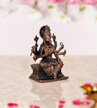Copper Varahi eight-armed figure sculpture from side view, seated on carved pedestal, 3 in