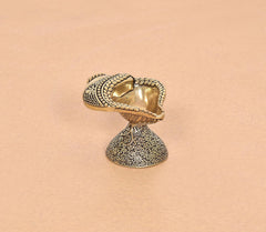 Brass conch shankh oil diya lamp side view, engraved shell bowl and speckled base