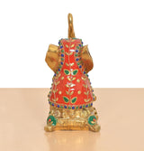 Brass elephant figurine rear view, red robe with green motifs and jeweled trim