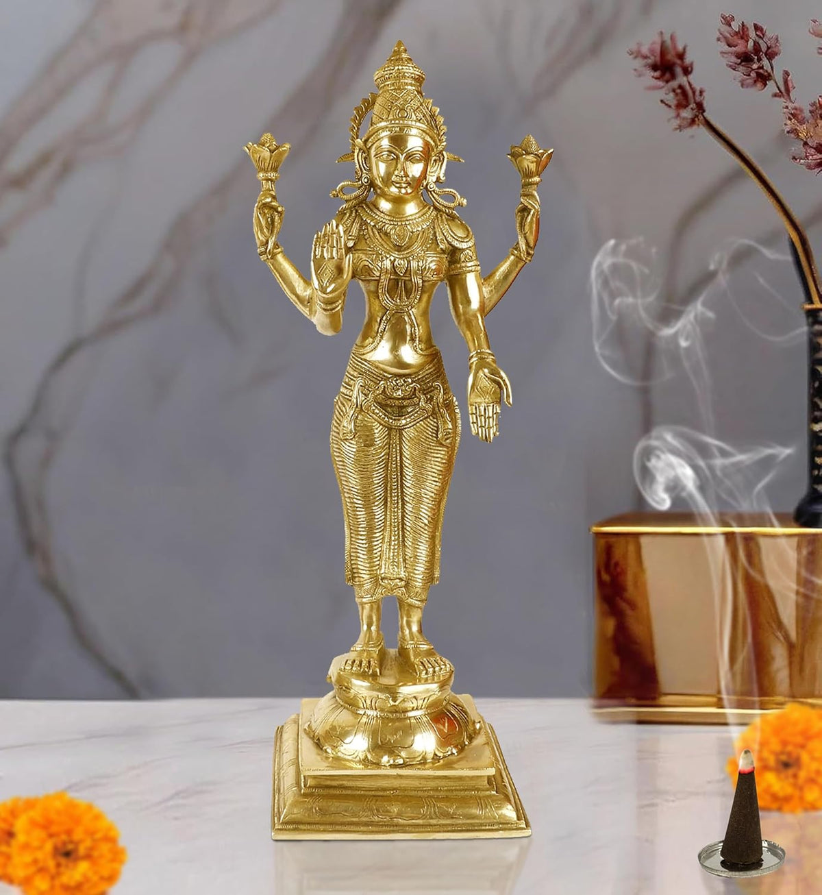 Brass standing Lakshmi goddess statue with four raised hands and engraved base