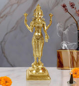 Brass standing Lakshmi idol with four arms, ornate jewelry and crown, home pooja decor