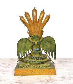Brass naga kanya statue, back view: cobra hood and wing-like fans on green base