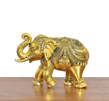 Golden brass elephant figurine, detailed head and trunk with engraved saddle pattern.