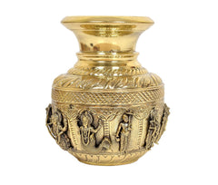 Brass kalash showpiece with sculpted deity panels and engraved leaf border
