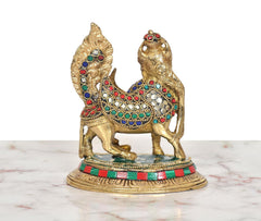 Brass Kamadhenu cow calf with wings, front view on round base with enamel border