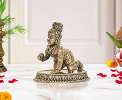 Bronze Bal Gopal Krishna idol, kneeling figure with beaded ornaments and raised hand