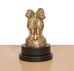 Brass Ashoka figurine rear view on revolving dark base with raised back detailing