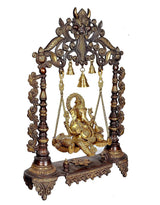 Brown and gold Ganesha swing, detailed frame with four hanging bells above seated Ganesha