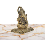 Rear three-quarter view of Lord Ganesha brass idol with detailed crown and patterned back.