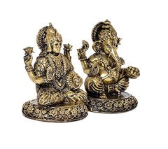 Close-angle of brass Lakshmi and Ganesh idols with jeweled detailing