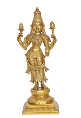 Brass Lakshmi statue standing with four raised arms, decorative crown, full view on base.