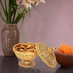 Gold metal dry fruit bowl showpiece with lid, holding almonds, table decor