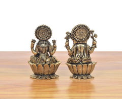 Rear view of bronze Lakshmi and Ganesha mini statues seated on lotus bases.