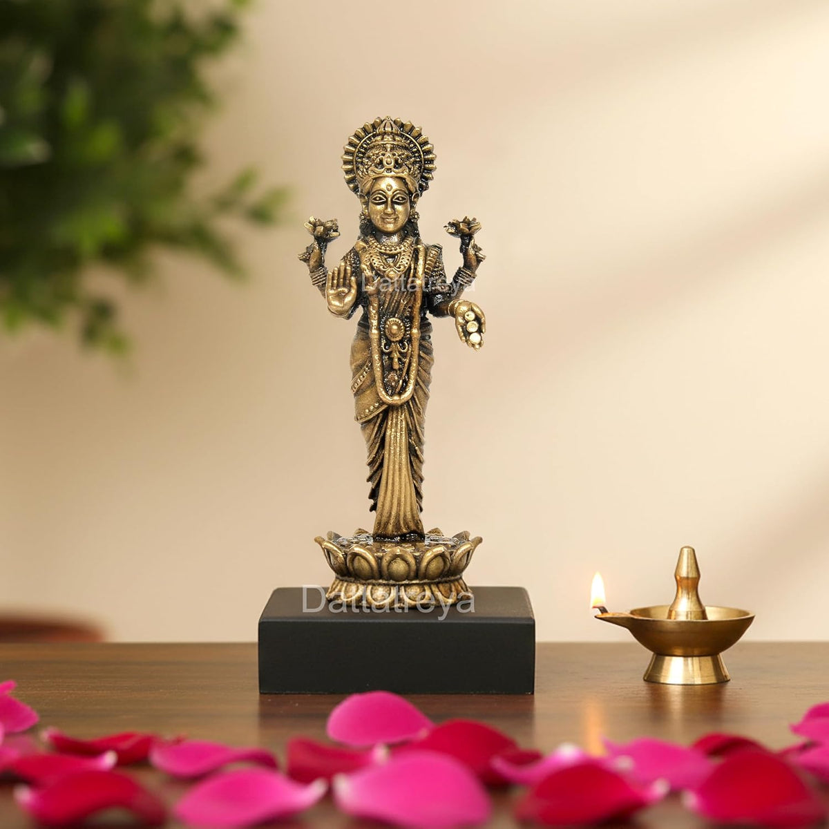 Panchaloha standing Lakshmi statue, gold-toned deity with raised hands on black base