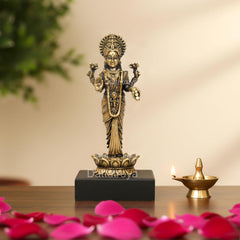 Panchaloha standing Lakshmi statue, gold-toned deity with raised hands on black base