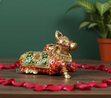 Brass seated Nandi statue, gold with red and green jeweled patterns