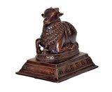 Nandi bull idol in dark bronze brass, ornate neck beads, side view on pedestal