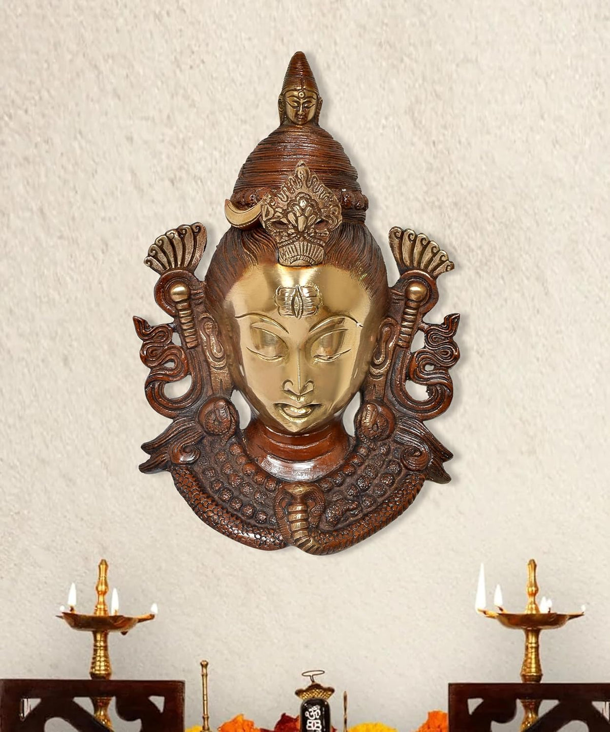 Brass Shiva face wall hanging mask with ornate arch, gold and dark brown detail