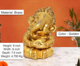 Brass Bal Ganesha murti, seated with hands clasped, detailed jewelry, golden