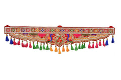 Decorative peacock toran banner with patterned red band and multicolor hanging tassels