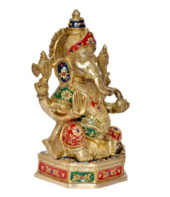 Brass Lord Ganesha idol, side view, red and green jewel patterns on seated pedestal base