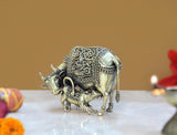 Small brass cow with calf idol, side view, decorative engraved frame panels