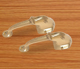 Brass Ganesha face door handle pair, curved levers with decorative grip ridges