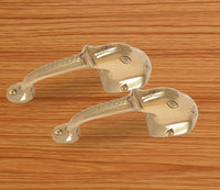 Brass Ganesha face door handle pair, curved levers with decorative grip ridges
