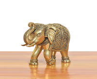 Bronze elephant figurine in profile, ornate filigree on back and head details