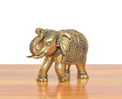 Bronze elephant figurine in profile, ornate filigree on back and head details
