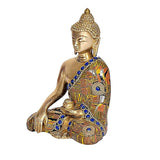 Seated Gautam Buddha idol in brass with blue gem accents and patterned robe