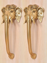 Brass Ganesha face door handle pair in golden finish, close view of elephant head details