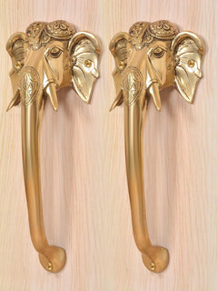 Brass Ganesha face door handle pair in golden finish, close view of elephant head details