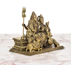 Shiv Parivar brass murti side view with trident staff and small seated figures on base