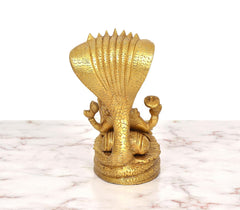 Golden brass Sheshnag hood idol base, rear view of seated figures