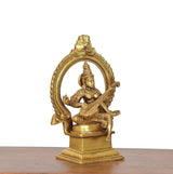 Brass Saraswati idol angled view, seated veena player inside decorative oval halo