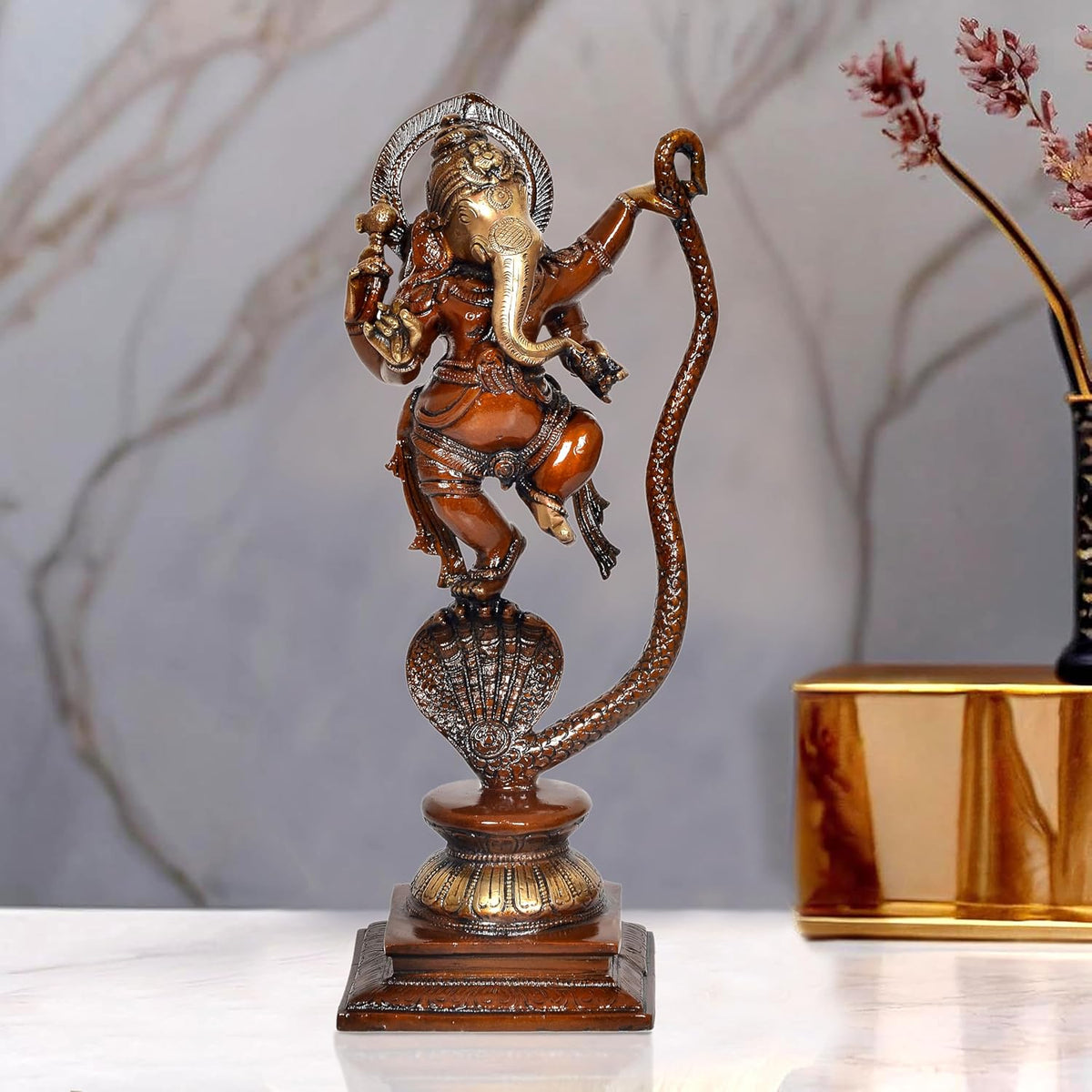 Dancing Lord Ganesha idol on serpent Shesha, brass and brown-gold finish