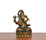 Brass Lord Ganesha idol angled view, seated posture with four arms and detailed halo