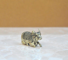 Brass Nandi bull figurine in standing pose, ornate patterned back and saddle