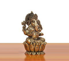 Bronze Lord Ganesha idol, angled view, four arms raised, seated