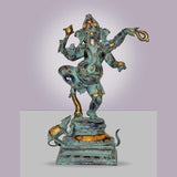 Dancing Ganesha idol statue with turquoise finish and gold accents, raised arms