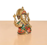 Brass Ganpati murti, three-quarter view, multicolor jeweled outfit and raised hand