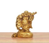 Brass laughing Buddha standing statue, gold tone, holding coins and staff, side view