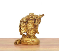 Brass laughing Buddha standing statue, gold tone, holding coins and staff, side view