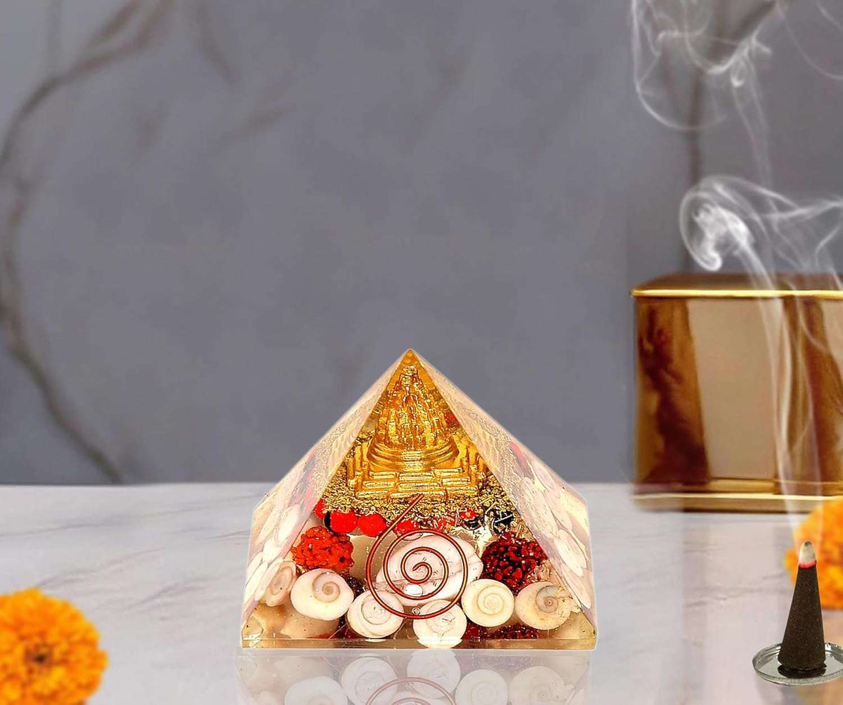 2-inch orgonite chakra pyramid, gold top with red accents and white shell pieces