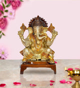 Brass Lord Ganesha idol statue with raised hands on wooden base