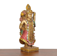 Resin Shreenathji murti three-quarter view, pink skirt, gold ornaments, green drape