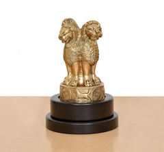 Brass Ashoka figurine with sculpted garland details on revolving dark base plaque