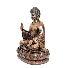 Resin Buddha idol side view, head turned, palm-up blessing pose, textured lotus base