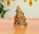 Brass Ganesha statue blowing conch shell, multicolor accents, 3-inch height